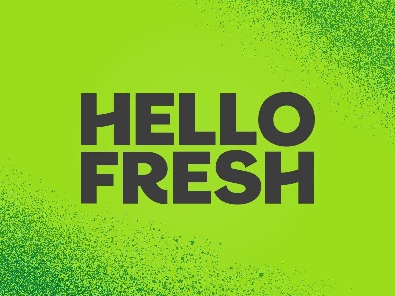 HelloFresh logo on a bright lime-green background with a speckled design.